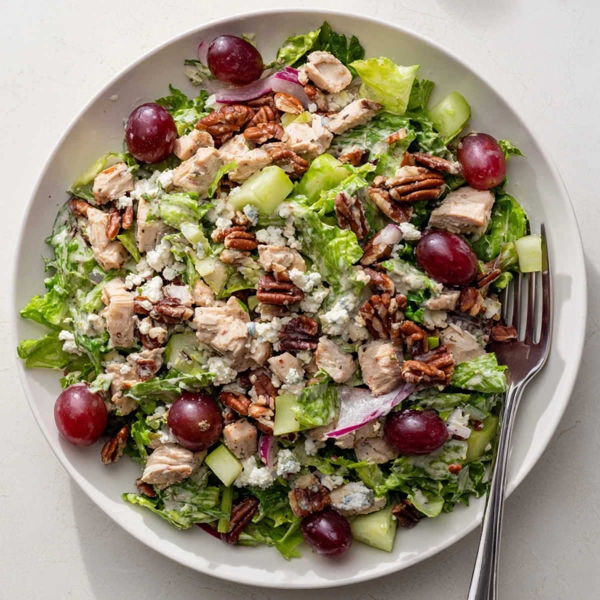 Savory Chicken Pecan Salad with Dressing highlights golden toasted pecans, crumbled feta cheese, and glossy dressing clinging to every crisp lettuce leaf.