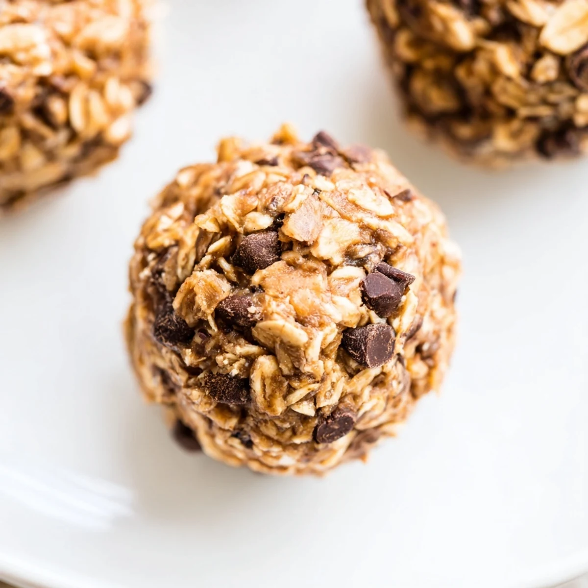 Easy No Bake Chocolate Chip Energy Bites arranged on parchment, ready for a quick healthy snack on the go.