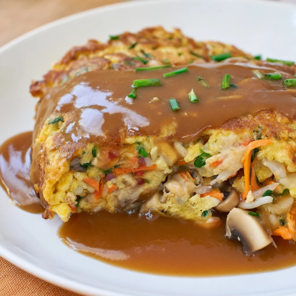 Crispy fried Egg Foo Young served hot with steaming brown gravy sauce