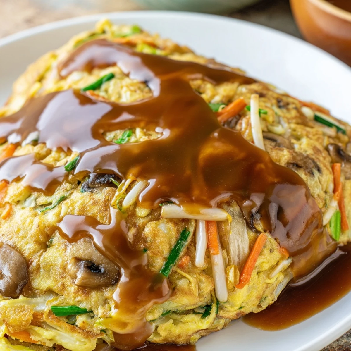 Fluffy Chinese omelet patties with colorful vegetables and tender meat pieces
