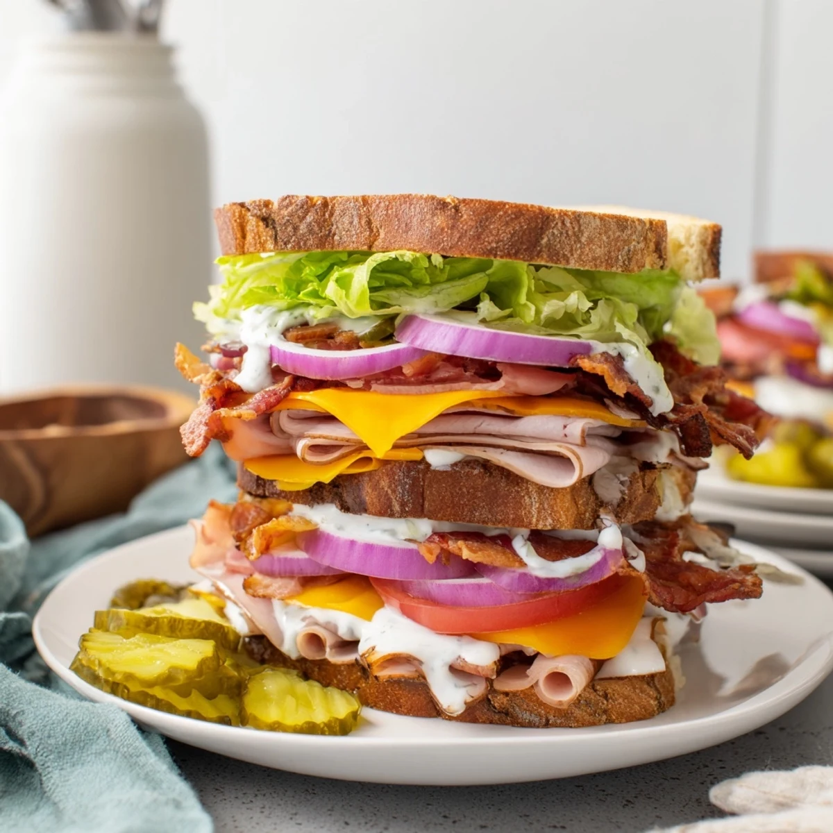 Triple meat ultimate turkey beef bacon ranch sandwich with cheddar Swiss lettuce tomato and creamy ranch dressing