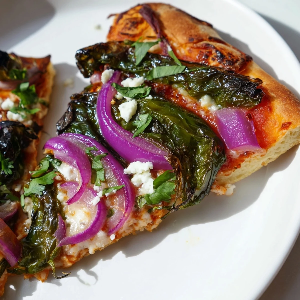 Golden crust Poblano Pizza with Cilantro topped with roasted peppers, melted mozzarella, and fresh green cilantro leaves