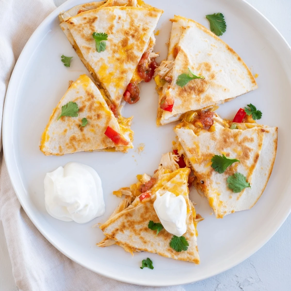 Mexican-style chicken quesadillas pan-fried to golden perfection with oozing Monterey Jack cheese