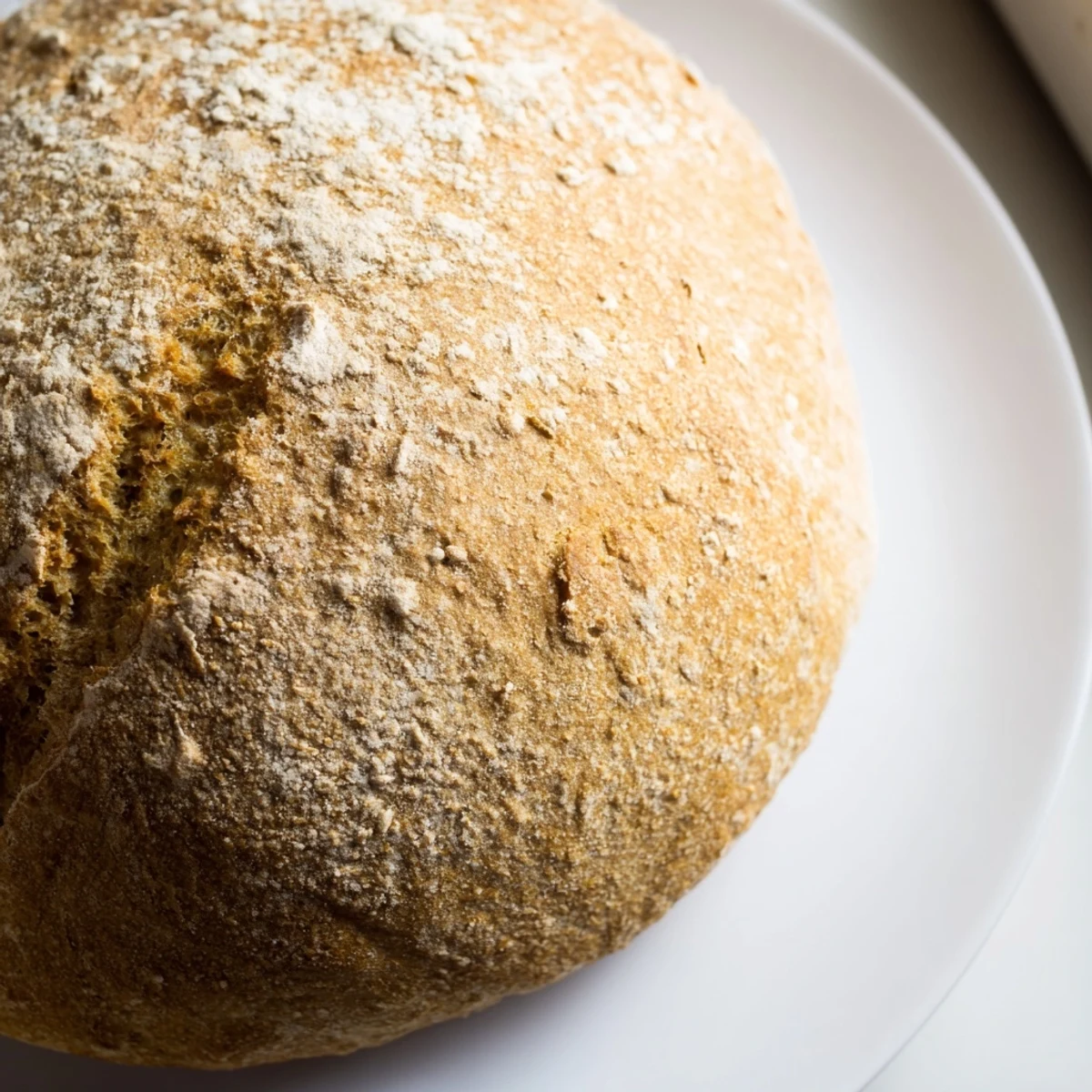 Soft pan-cooked bread broken into warm pieces, showing tender white interior perfect for serving with butter or olive oil