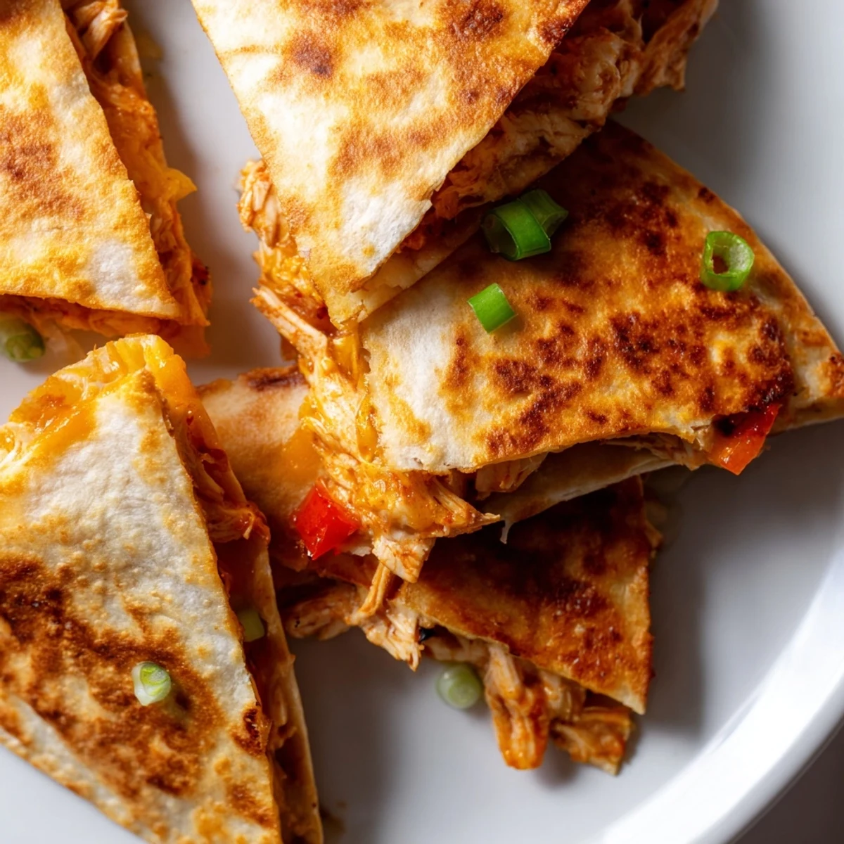 Golden baked chicken and cheese quesadillas with melted cheese and red bell peppers