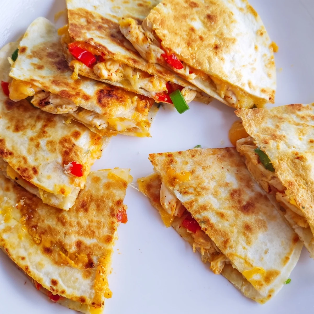 Easy chicken and cheese quesadillas cut into wedges ready for salsa and guacamole