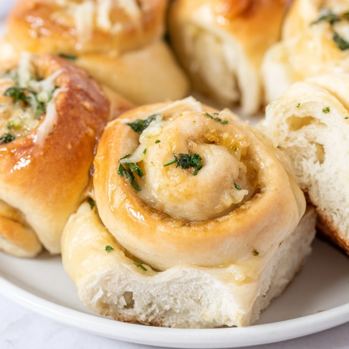 Warm homemade cheese garlic bread rolls oozing with mozzarella and rich buttery garlic filling