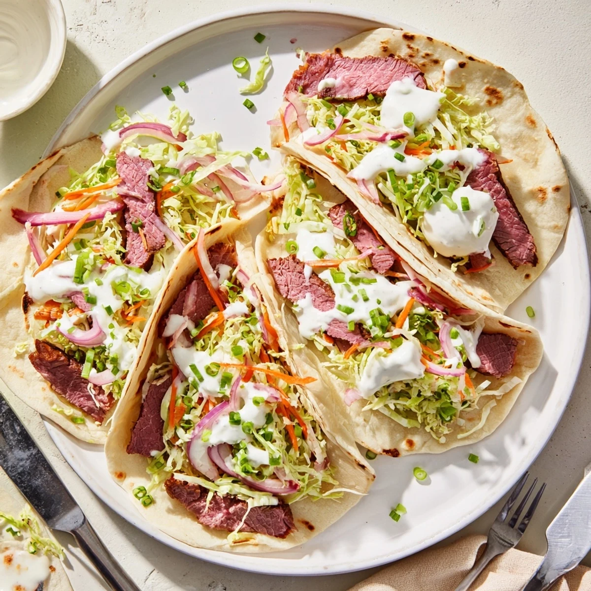 St. Patrick's Day fusion tacos featuring corned beef topped with zesty vegetable slaw