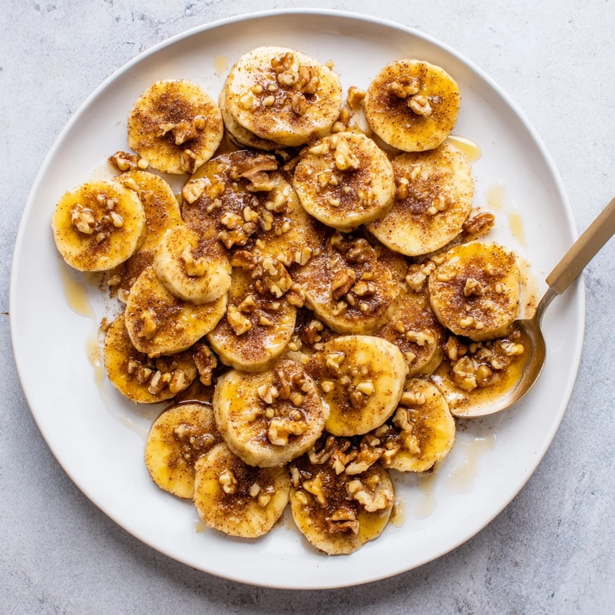 Warm caramelized banana slices coated in brown sugar and ground cinnamon, cooked to golden perfection