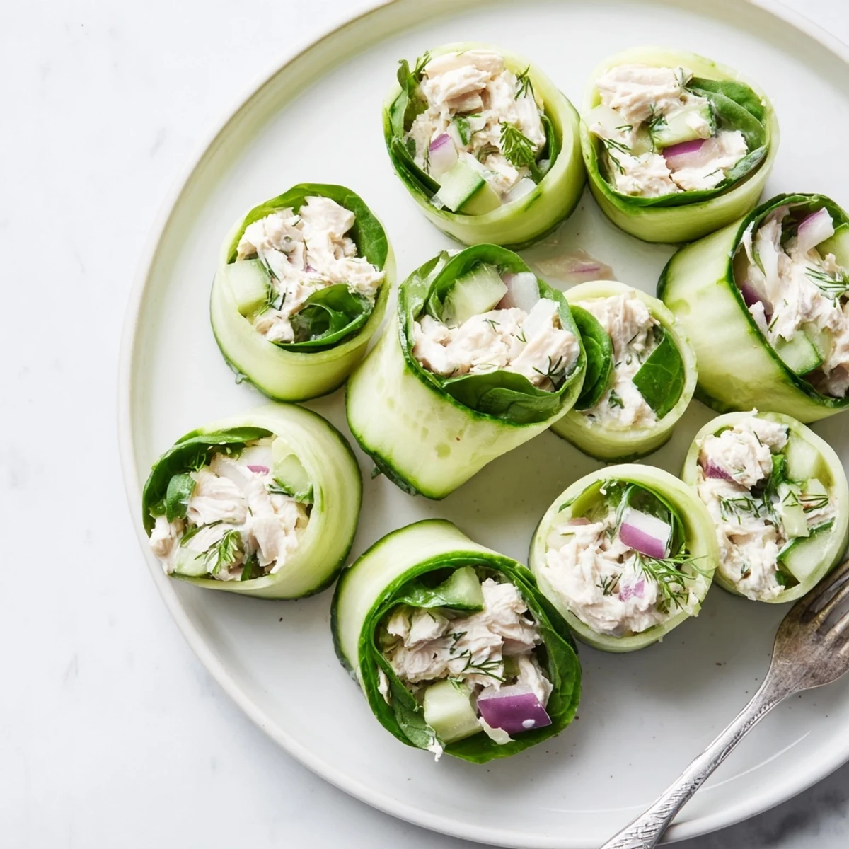 Fresh cucumber ribbons wrapped around creamy chicken salad filling for a light appetizer