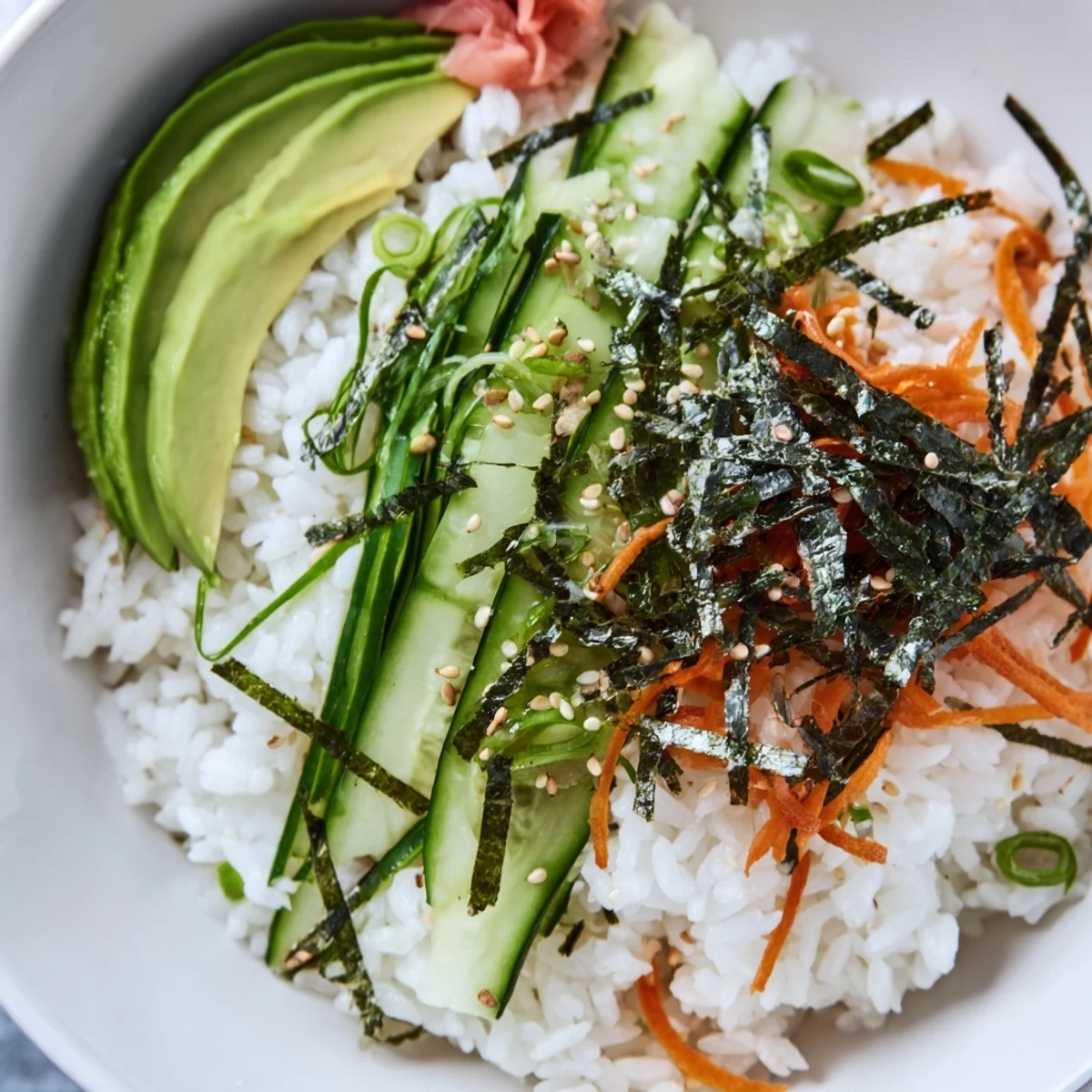 Family-style Sushi Cucumber Salad served chilled with avocado slices and pickled ginger