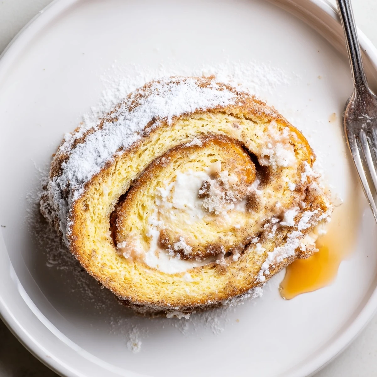 Warm Cinnamon Roll French Toast Roll Ups dusted with powdered sugar