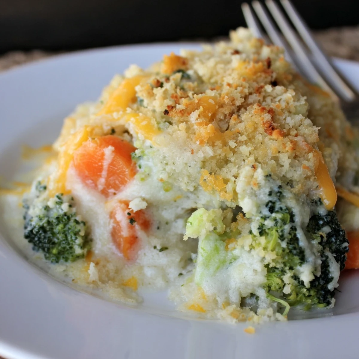 Golden, bubbling Cheese Bake Broccoli Carrots with crispy panko topping, steam rising.