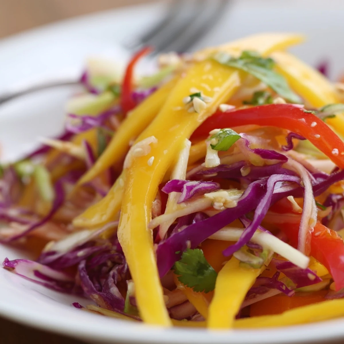 Chilled Refreshing Mango Slaw Recipe served alongside grilled fish, zesty and colorful