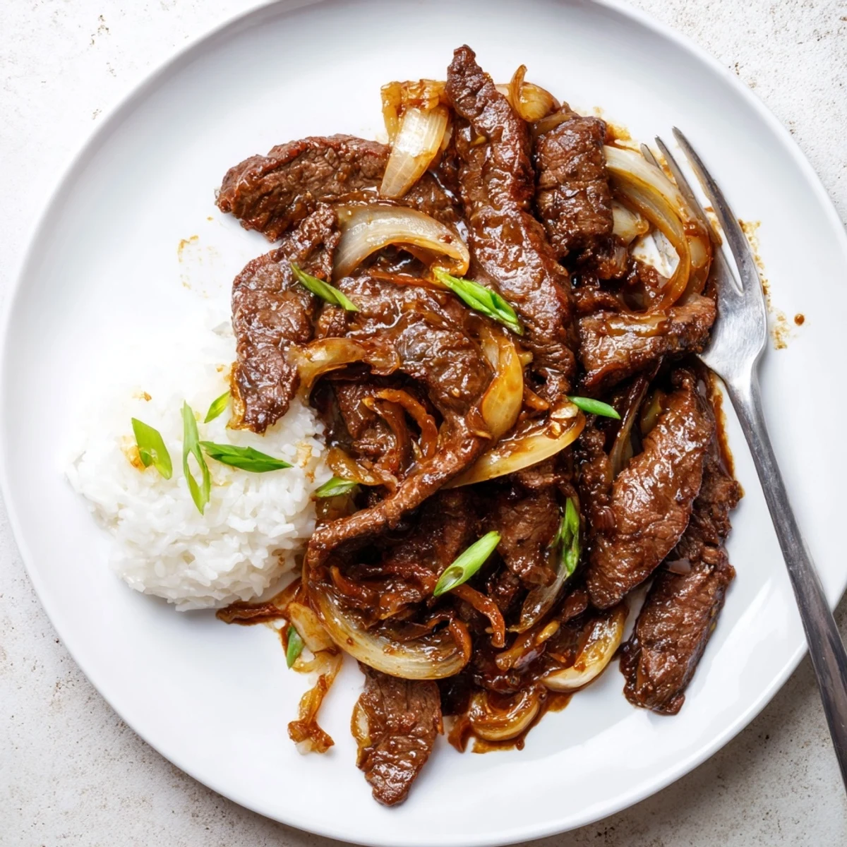 Caramelized onions and seared steak in Crispy Beef and Onion Stir Fry.