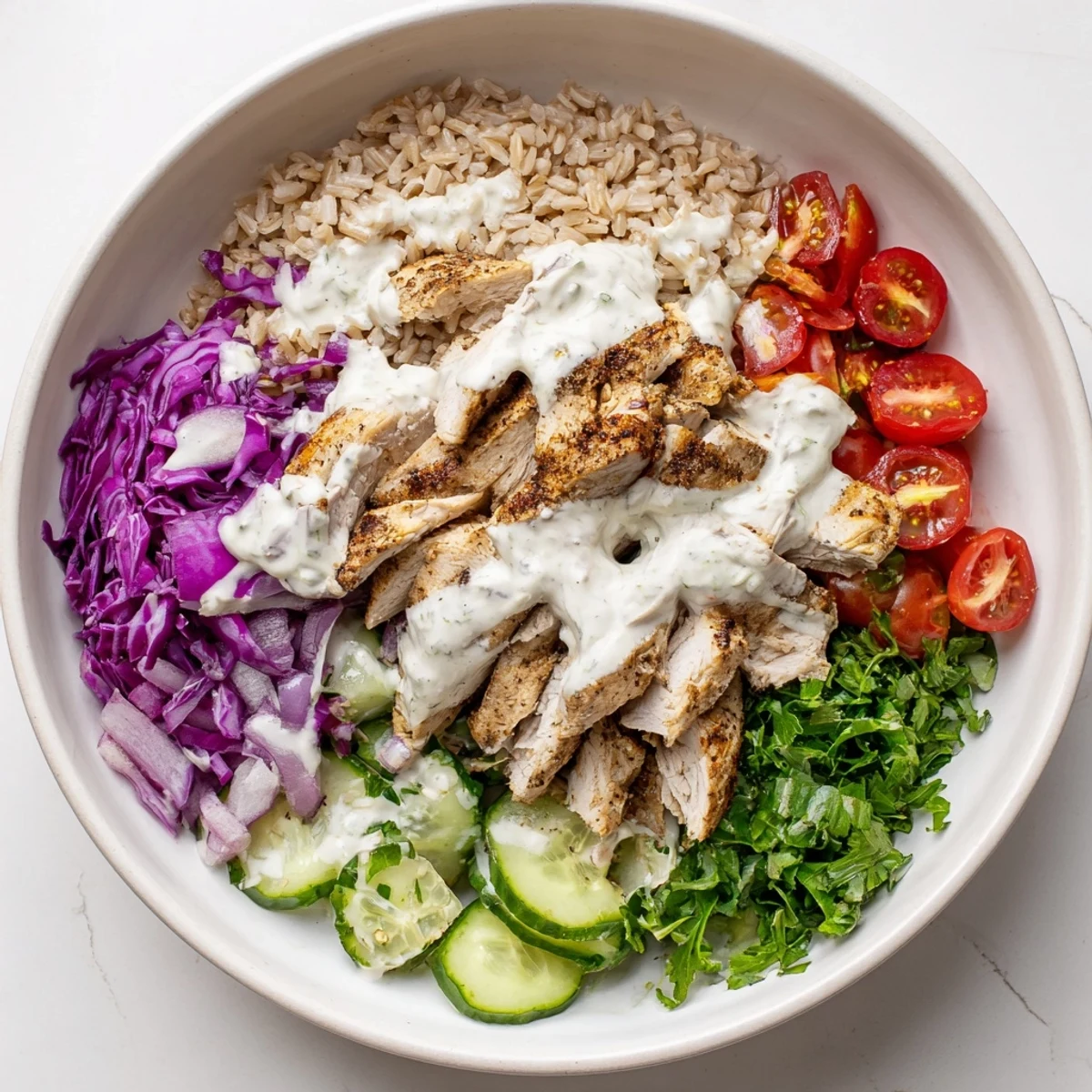 Healthy chicken shawarma bowl featuring juicy marinated meat with crisp veggies and nutty yogurt dressing