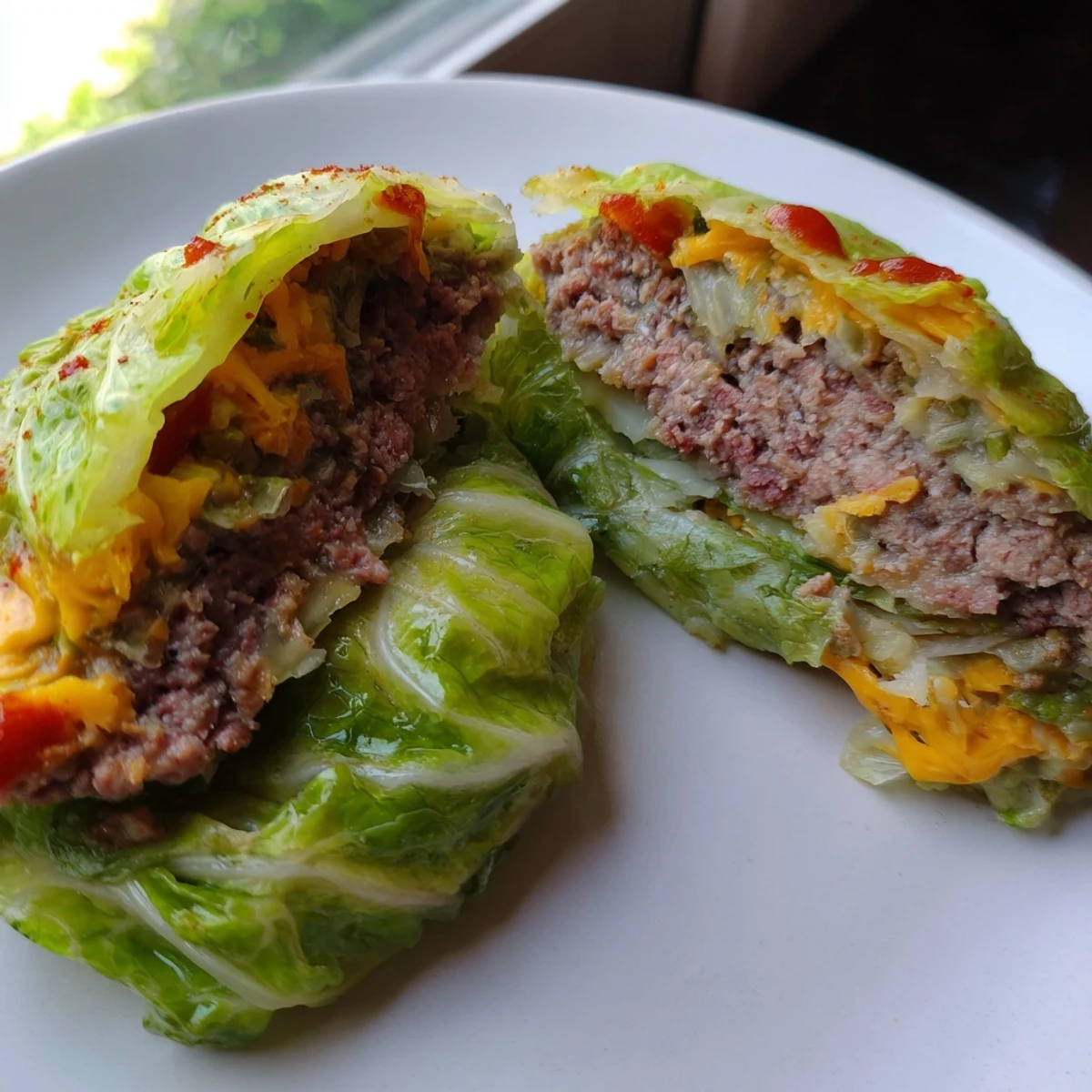 Juicy ground beef oven baked cabbage burger seasoned with paprika and melted cheddar cheese inside