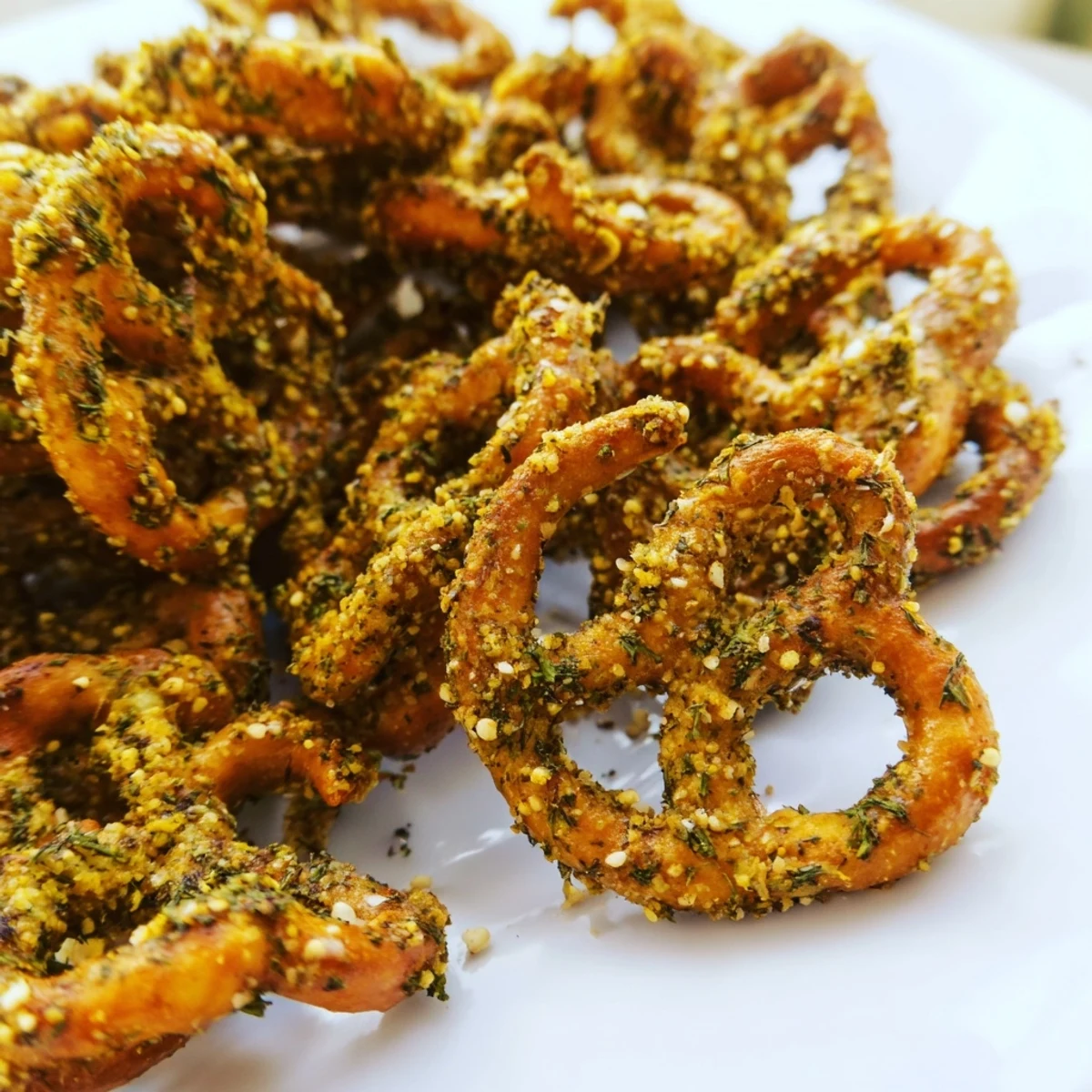 Crispy oven-baked pretzels coated with tangy dill pickle and ranch spices arranged for serving