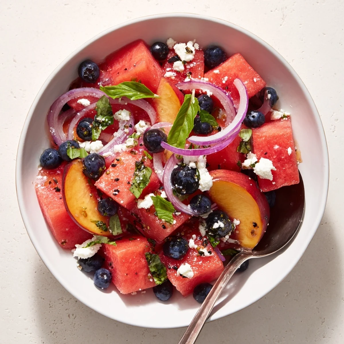 Peach Watermelon Salad With Feta glistening with lime, mint, and juicy peaches.