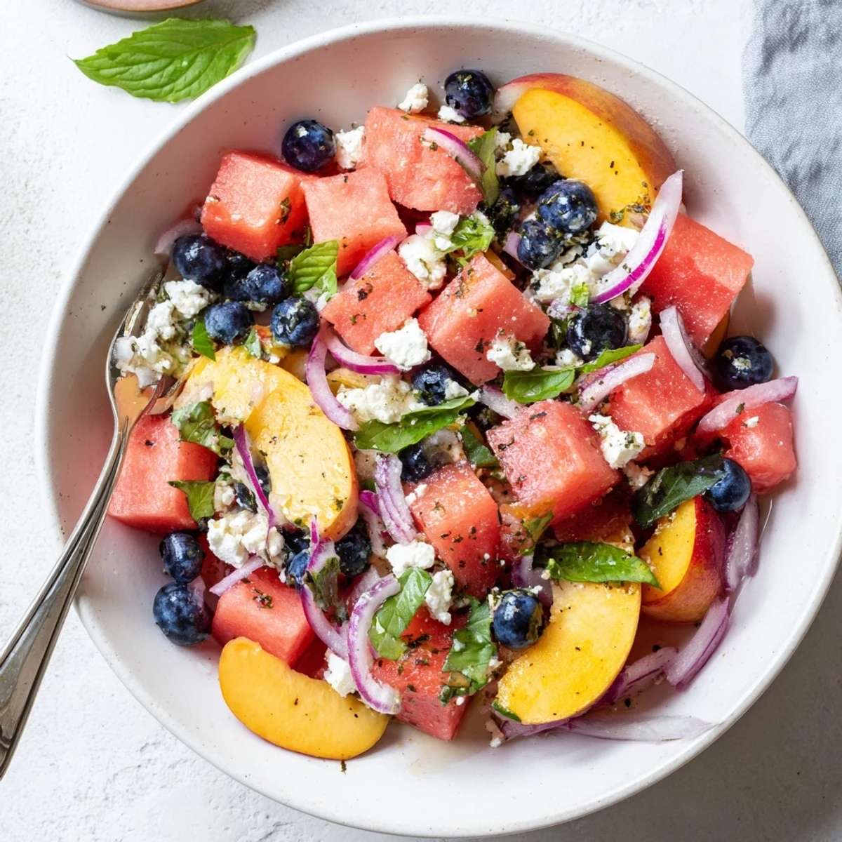 Bright Peach Watermelon Salad With Feta served alongside grilled chicken for summer.