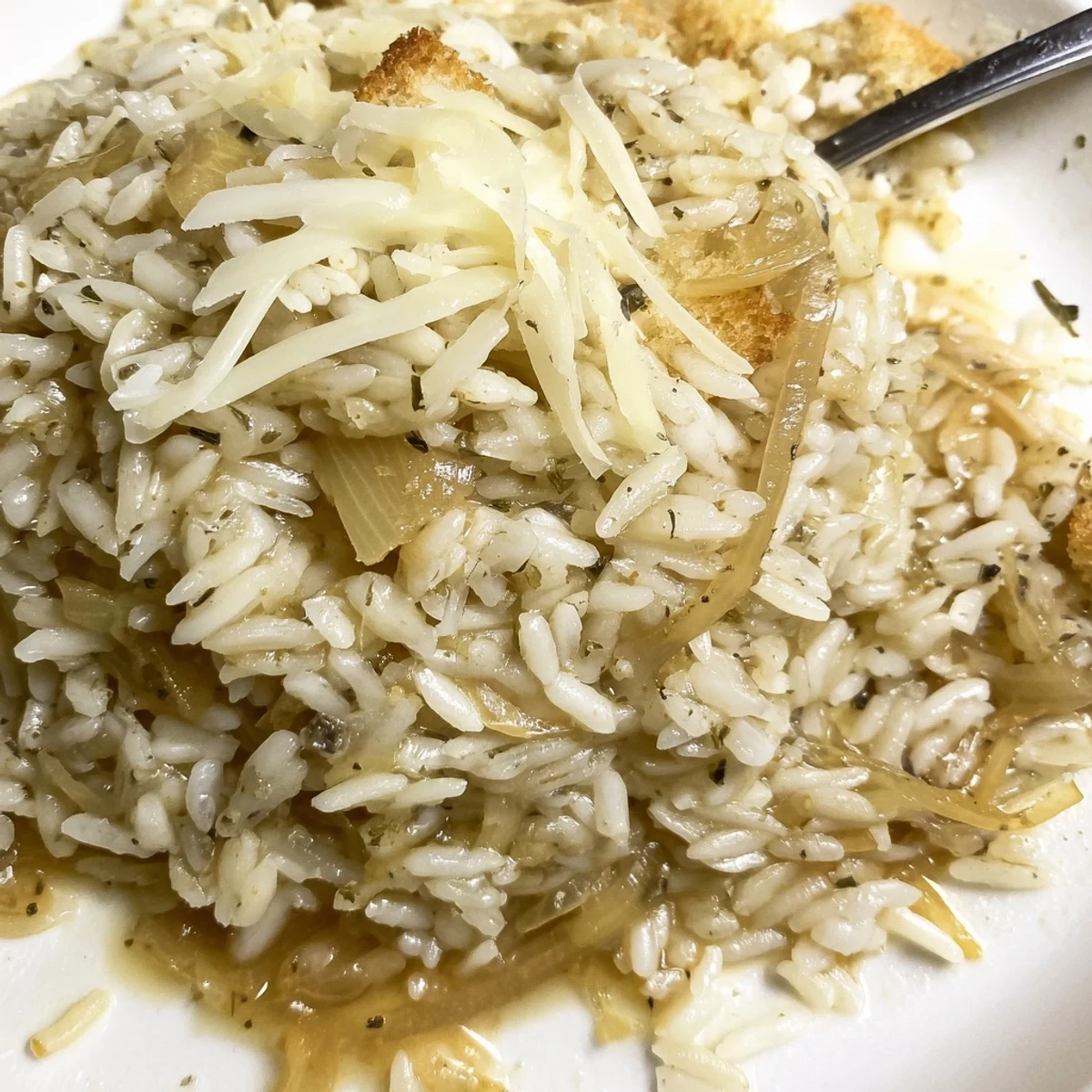 French Onion Soup Rice bubbling with melted Gruyère, caramelized onions, crusty croutons