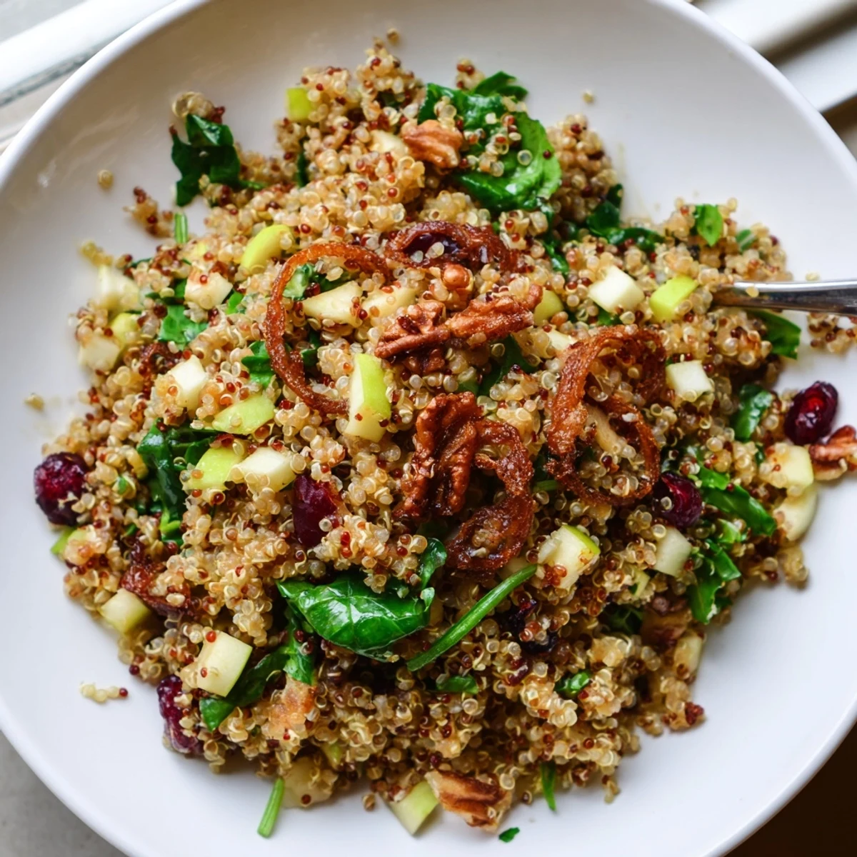Honey Mustard Quinoa Apple Salad studded with ruby cranberries and crunchy pecans, served fresh