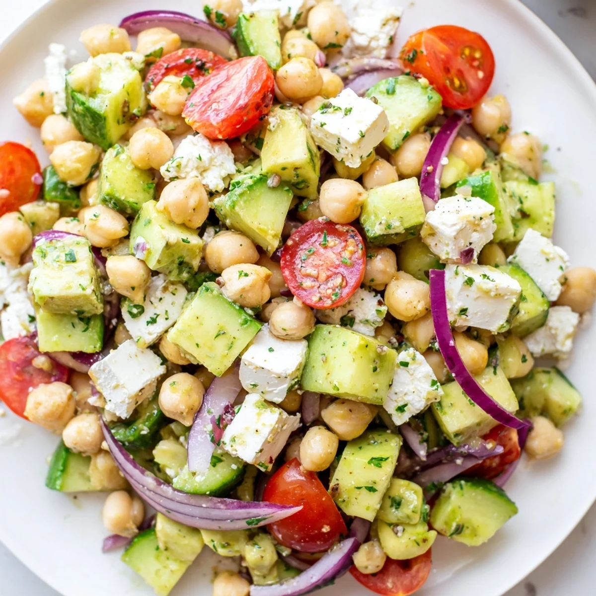 Chickpea feta avocado salad with juicy tomatoes and tangy lemon dressing