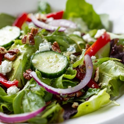 Tender spring greens tossed with crisp bell peppers, red onion, and tangy balsamic vinaigrette dressing.