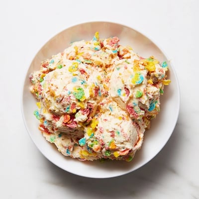 Creamy Fruity Pebbles Cereal Frosting with rainbow crunch, ideal for parties